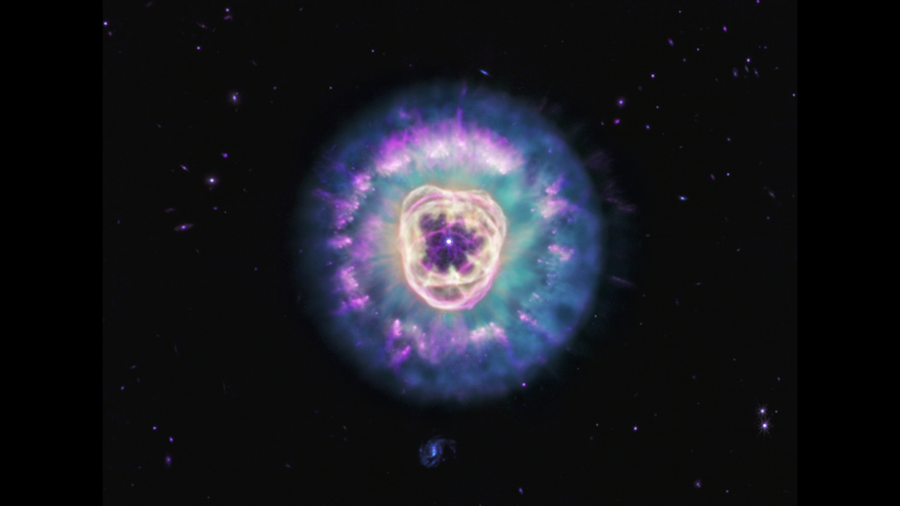 A purple center with a white dot at its center is surrounded by purple glowing layers.