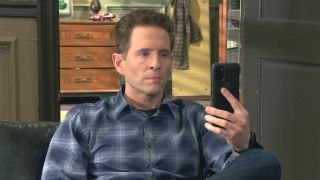 Dennis staring at his phone in It's Always Sunny in Philadelphia Season 16