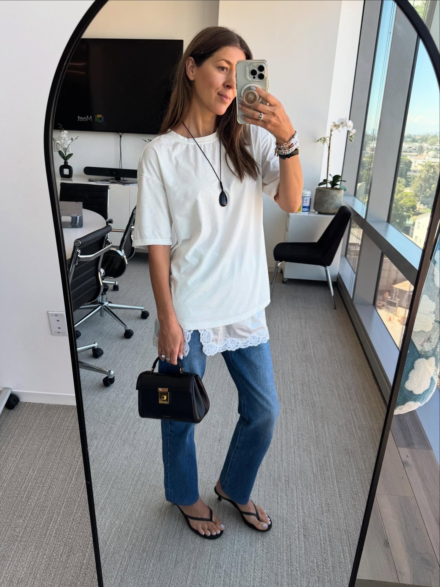 Woman in jeans, white tee, and lace slip