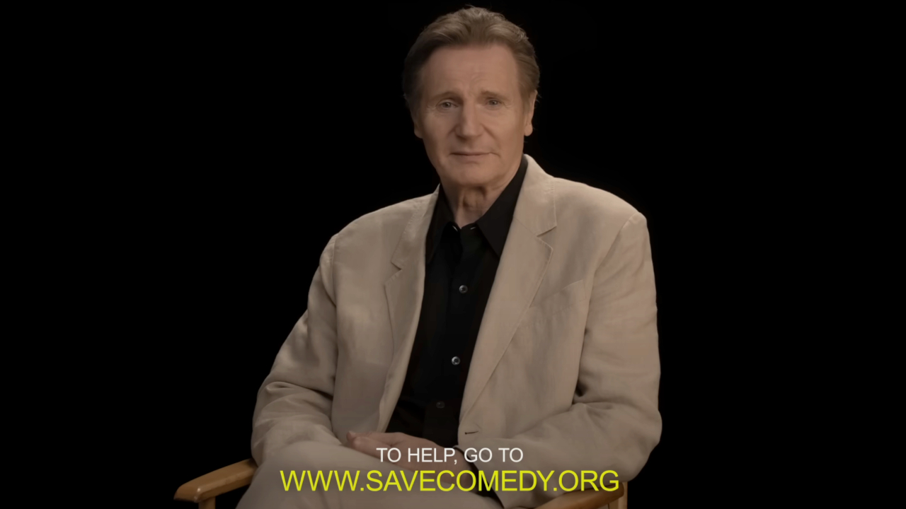 Liam Neeson sits stoically during the Save Comedy ad for The Naked Gun.