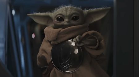 Grogu holding glass bulb in The Mandalorian and Grogu