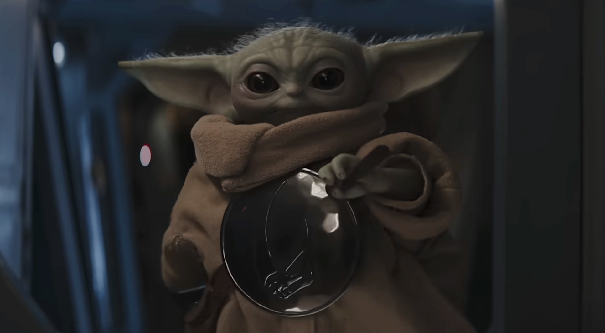 Grogu holding glass bulb in The Mandalorian and Grogu