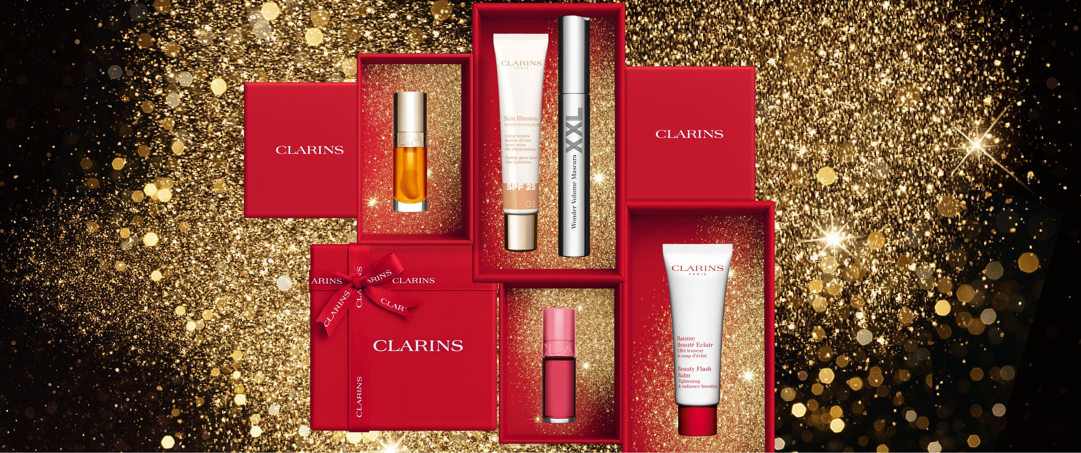 Clarins products in boxes on glitter background