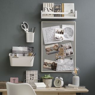 grey wall with wooden table and shelf