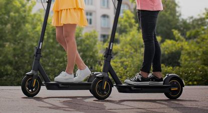 Best electric scooters: two people riding e-scooters