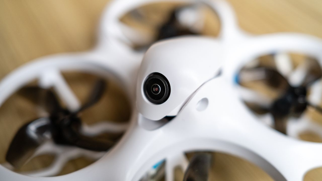 BetaFPX Cetus X drone on wooden table and closeup of its camera