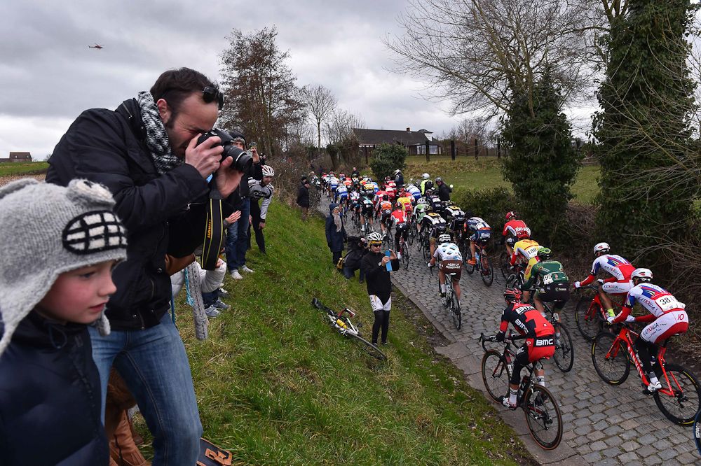 A fan finds a good spot for photos along the route.