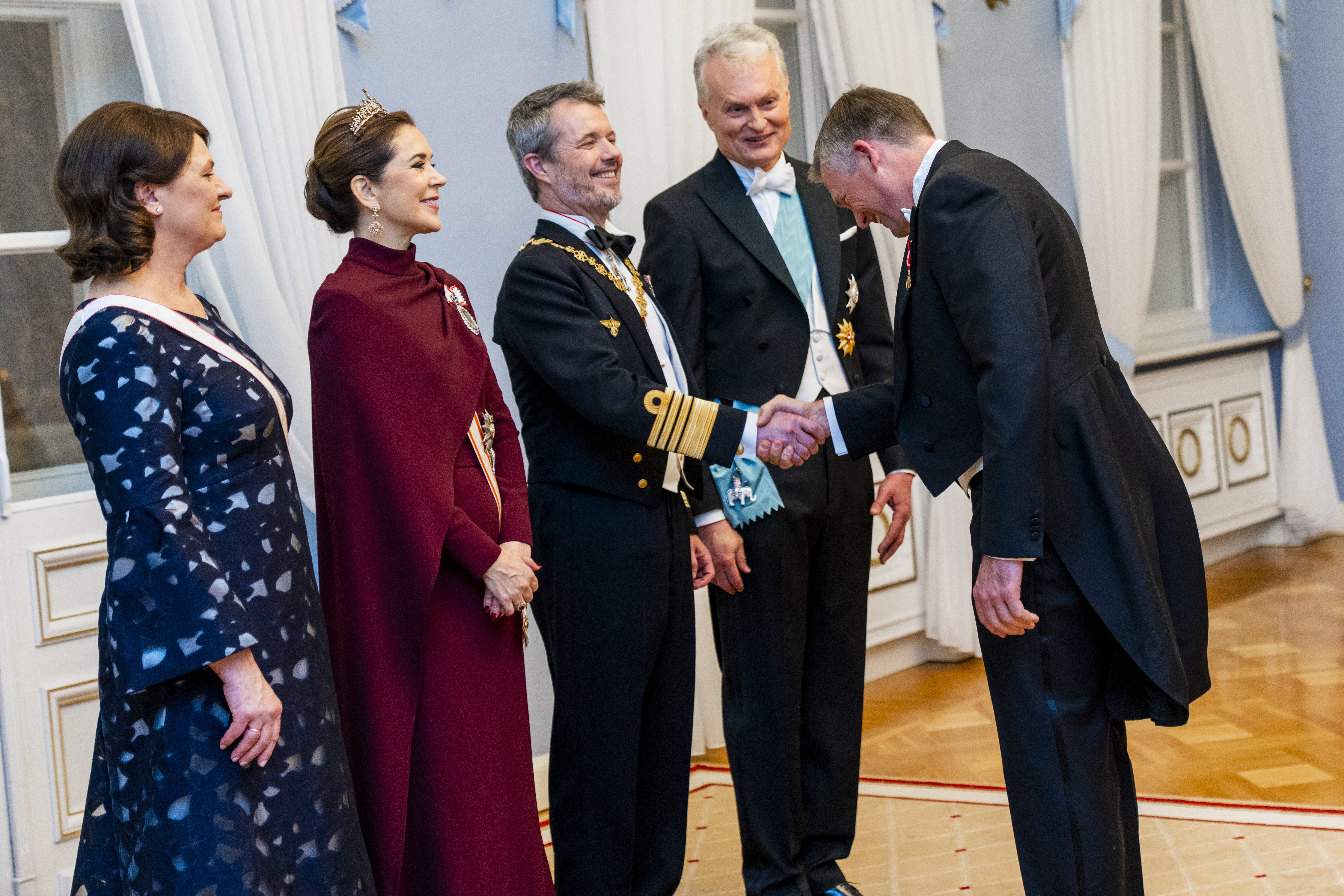 King Frederik X (C), Queen Mary of Denmark (2nd L), Lithuania's President Gitanas Nauseda (2nd R) and his wife Diana Nausediene (L) welcome Danish astronaut Andreas Mogensen (R) at a state banquet