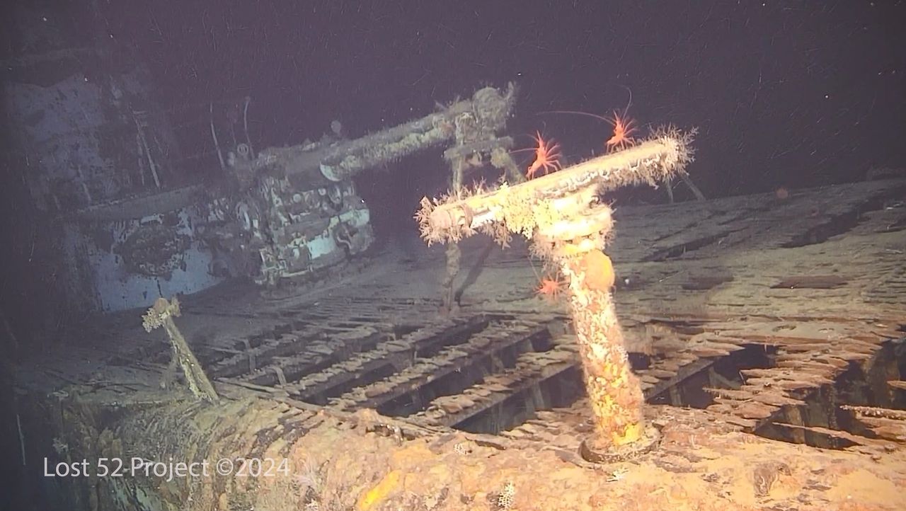A photo of the underwater submarine, with equipment covered in urchins and shrimp