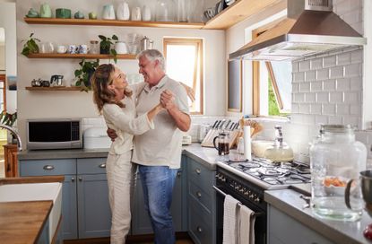 Couple dancing in a high-end kitchen