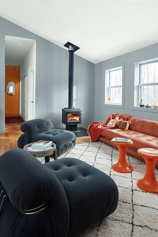 A grey living room with orange features