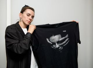 Lyndsey Gunnulfsen of the band Pvris hold the t shirt she designed exclusively for Louder