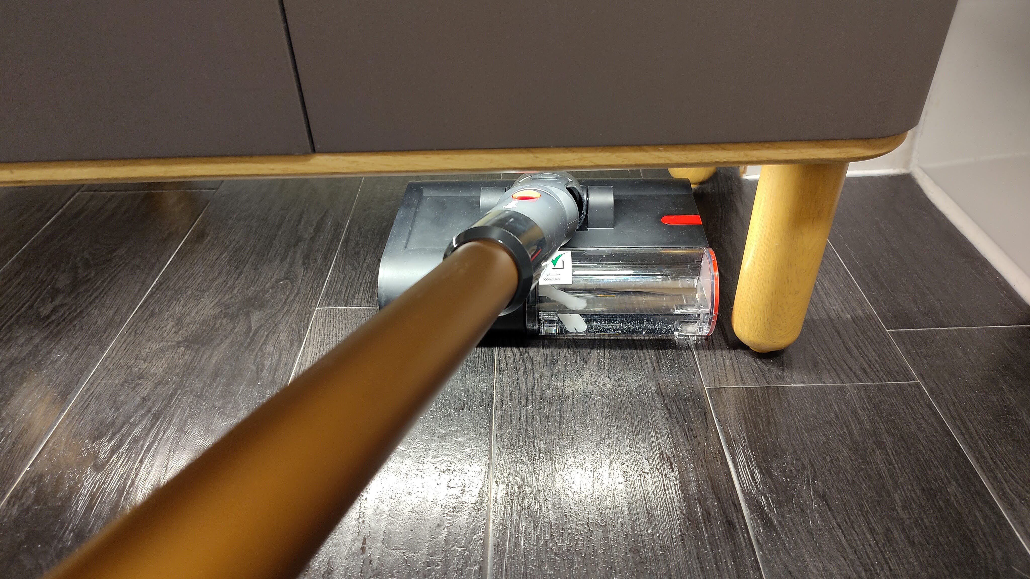 Dyson PencilWash being used to mop under cabinet
