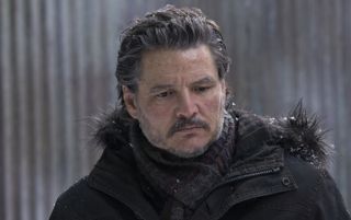 Pedro Pascal as Joel in a coat in winter looking unhappy