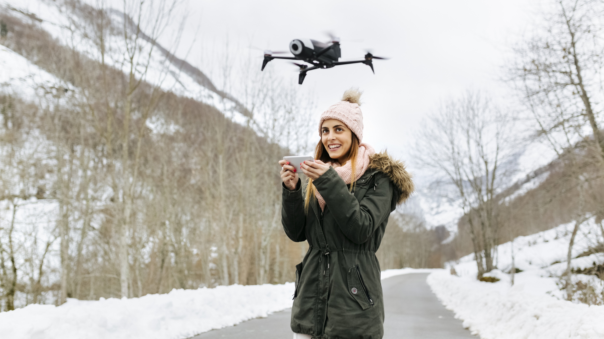 Drone Regulations: Everything You Need to Know: The image shows a woman flying a drone in the winter