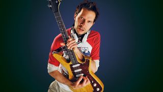 Portrait of American guitarist Paul Gilbert posing with his signature Ibanez PGM FRM1 Fireman guitar, on May 16, 2008. Gilbert is best known as a member of Racer X and Mr. Big. 