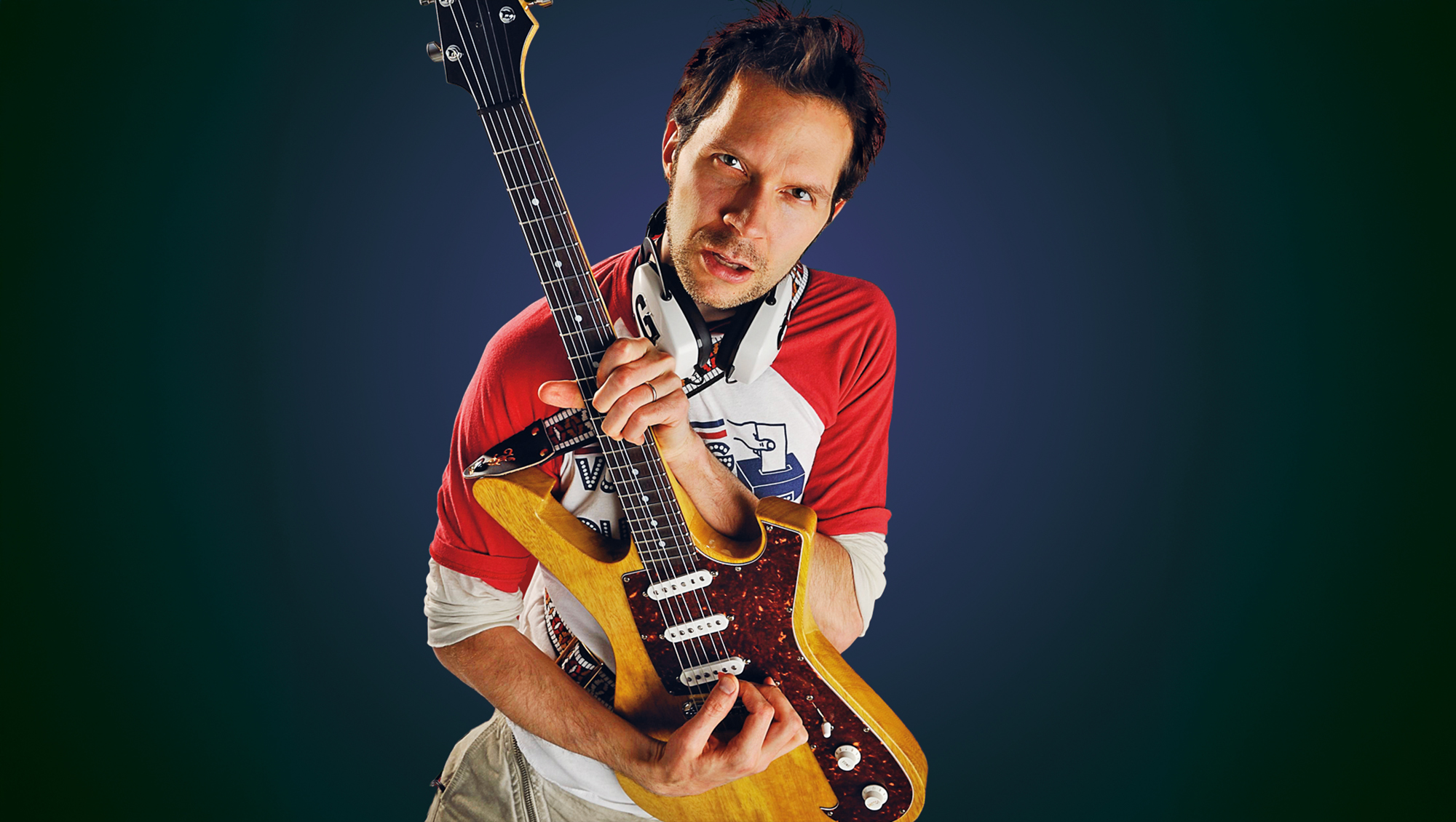 Portrait of American guitarist Paul Gilbert posing with his signature Ibanez PGM FRM1 Fireman guitar, on May 16, 2008. Gilbert is best known as a member of Racer X and Mr. Big.  