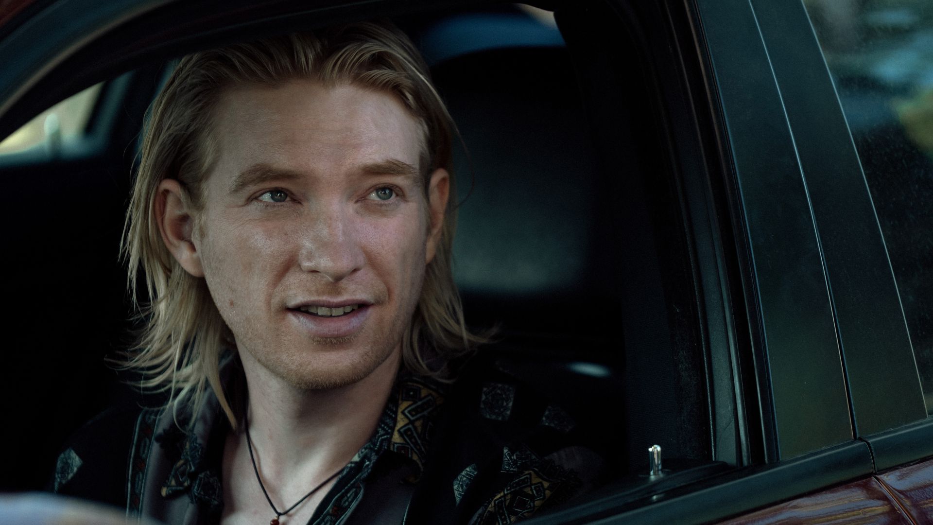 an image of Domhnall Gleeson in Echo Valley. He is sitting inside a car with the window open