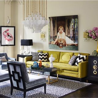 living area with yellow sofa and armchair and artwork