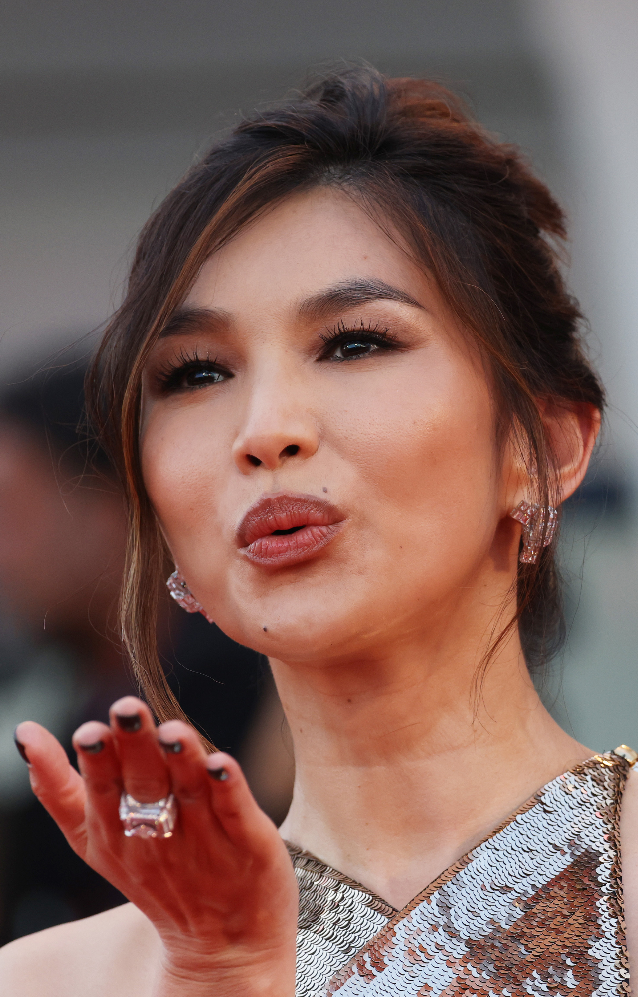 Gemma Chan blows a kiss on the Don't Worry Darling red carpet