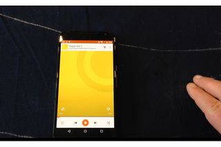 As I tap on the Project Jacquard fabric, I'm able to control playback on a nearby smartphone.