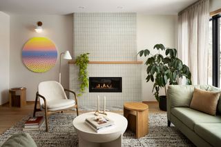 living room with tiled curved fireplace, in off whites, and with tall plant