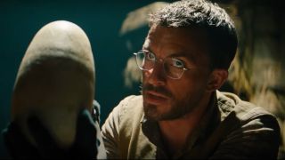 Dr. Henry Loomis (Jonathan Bailey) holds an egg in Jurassic World Rebirth