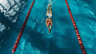 Woman swimming in an indoor pool