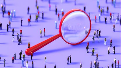 A giant, red magnifying glass surrounded by model people on a purple landscape to represent hidden tech talent.