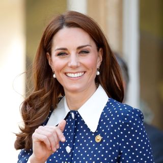 Kate Middleton smiling wearing a polkadot collared dress