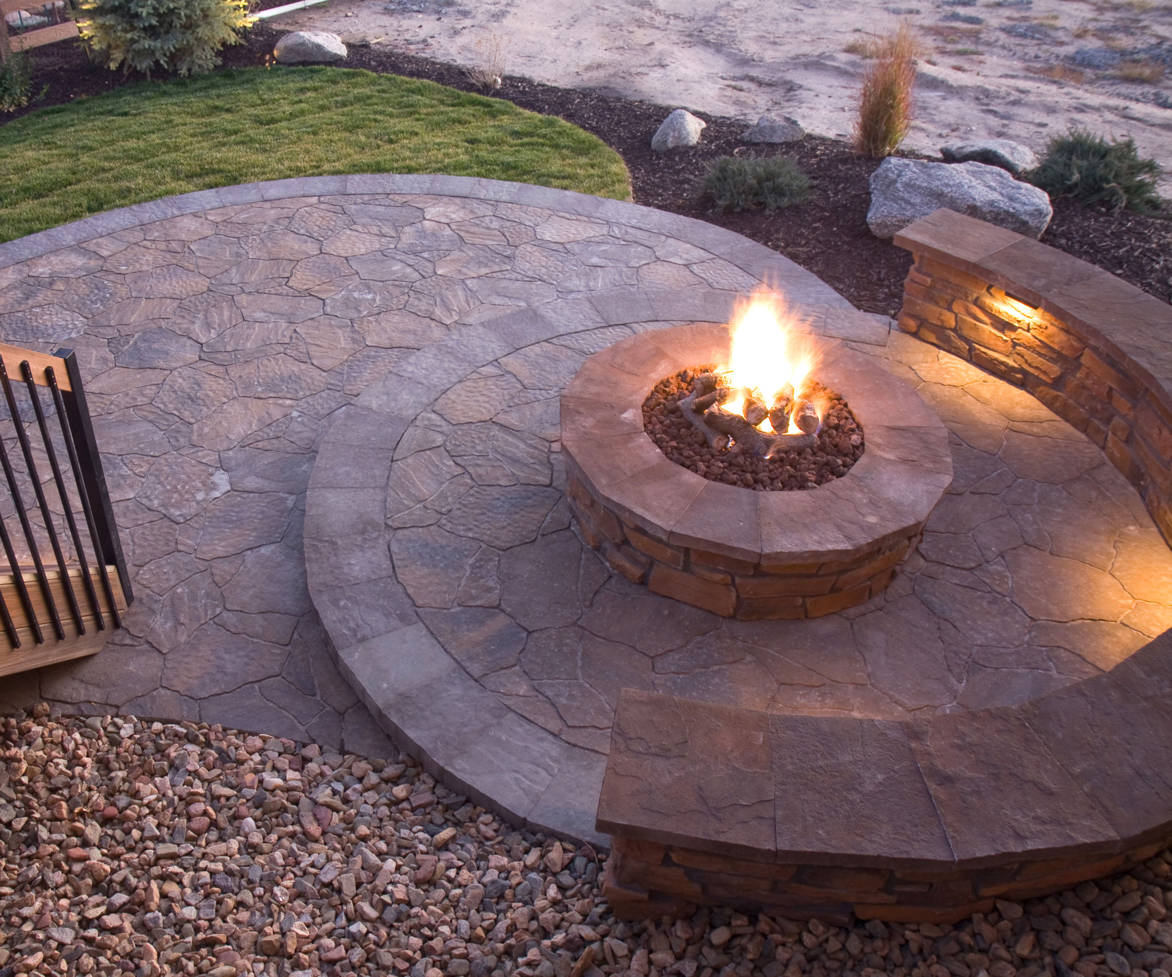 circular patio design with low wall and firepit