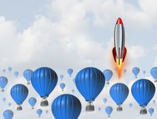 a rocket among blue hot-air balloons