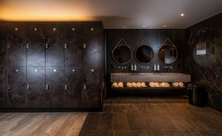 The designers used a rich blend of backlit dark tinted mirror, bronze accents along with warm Cognac-coloured leather
