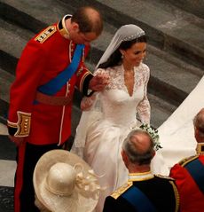 Prince William bowing and Kate Middleton curtsying to Queen Elizabeth at their wedding