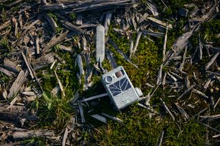 the Zeiss Secacam 3 on the floor of a forrest surrounded by moss and bark