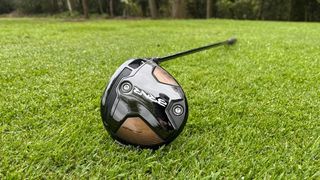 TaylorMade BRNR Mini Driver resting on the golf course showing off its mini clubhead