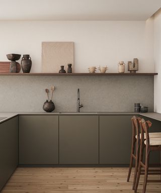 modern kitchen with dark gray cabinets, open shelving, gray backsplash, bar stools on one side, wooden floor, artisan vases and artwork