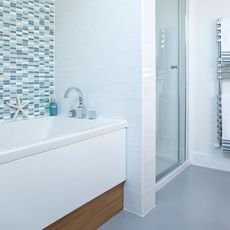bathroom with shower unit and blue tiles