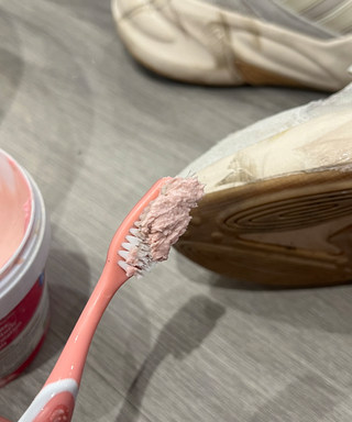 A pink toothbrush with the Pink Stuff paste
