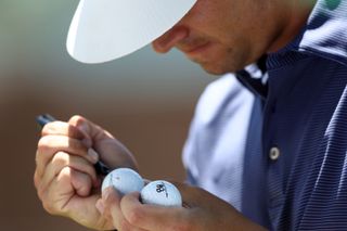 Hossler marks up his golf balls