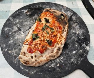 Cooked calzone on the Gozney serving platter.