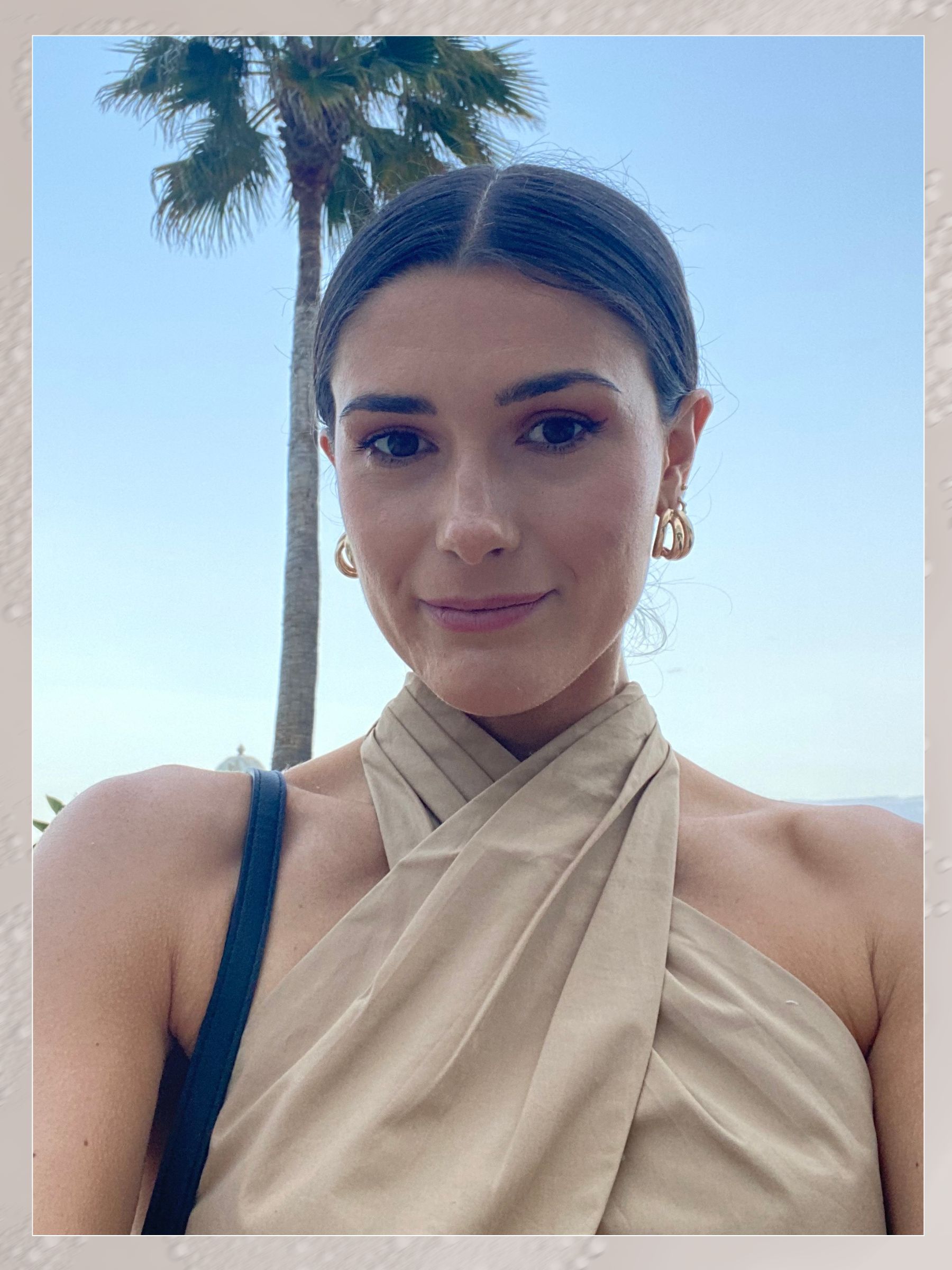 A selfie of Eleanor wearing a halterneck top and a slicked-back bun