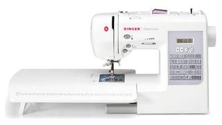 Best sewing machines for quilting; a large Singer sewing machine with an extension table