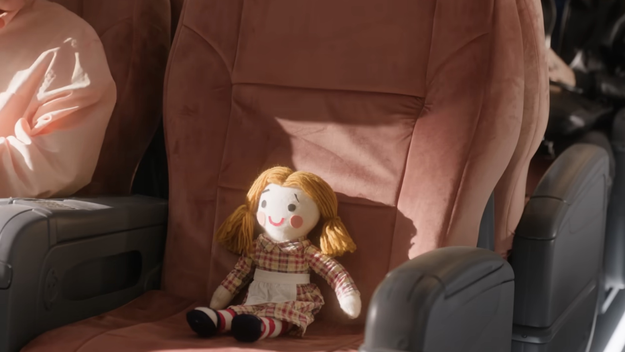The red headed doll in a seat during Stop! That! Train!