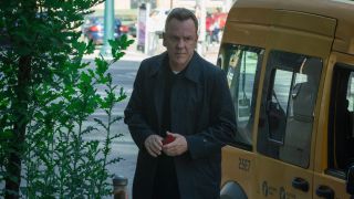 Kiefer Sutherland walking away from a car in Rabbit Hole