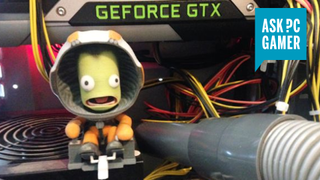A vacuum nozzle under a graphics card (with a bonus terrified Kerbal toy watching on)