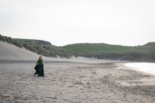 DI Ruth Calder (ASHLEY JENSEN) on the beach, running into the sea fully clothes in Shetland season 8