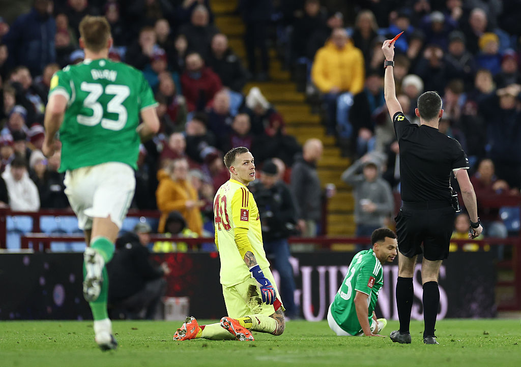 BIRMINGHAM, ENGLAND - FEBRUARY 14: Marco Bizot of Aston Villa is shown a red card by referee Chris Kavanagh for a foul on Jacob Murphy of Newcastle United during the Emirates FA Cup Fourth Round match between Aston Villa and Newcastle United at Villa Park on February 14, 2026 in Birmingham, England. (Photo by Dan Istitene/Getty Images)