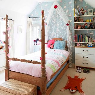 girls bedroom with book shelves and wallpaper wall