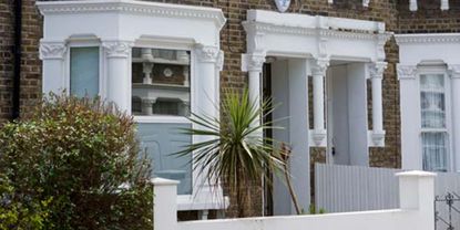 house exterior with bricked wall and white window